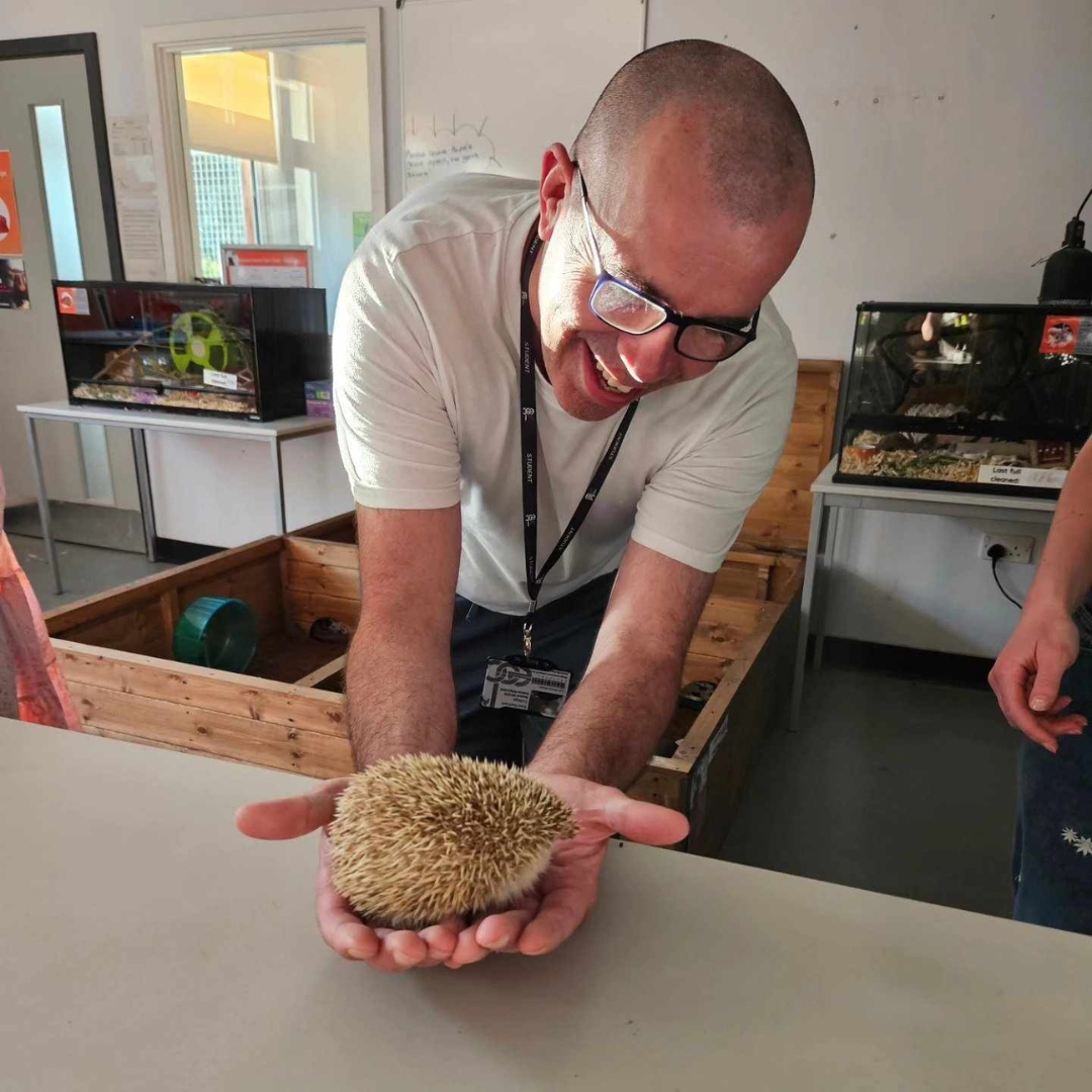 Picture of EDC student holding a hedgehog.