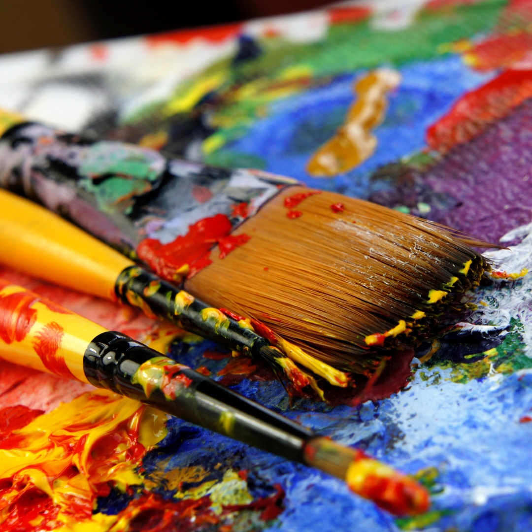 Paint brushes, laid on table.