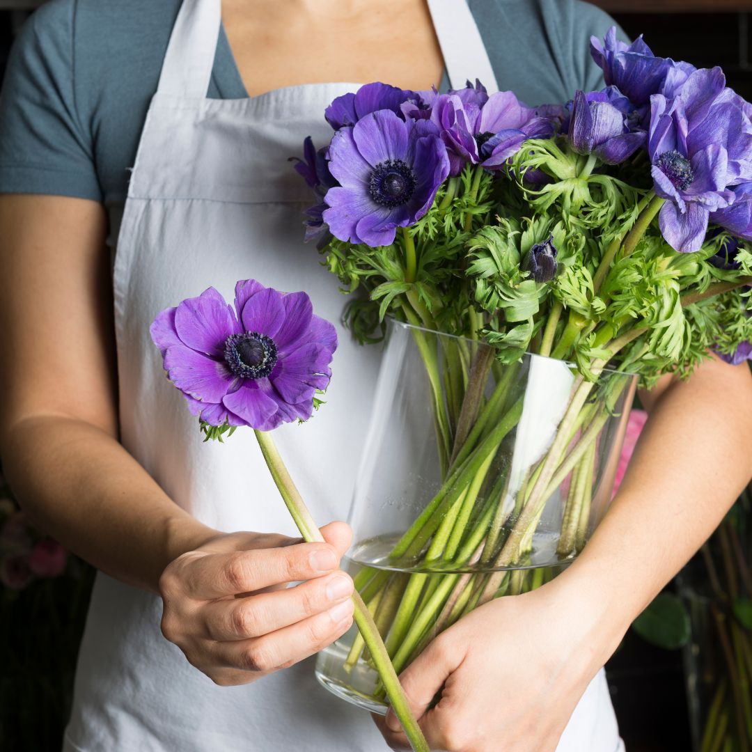 Man stood at table in florist.